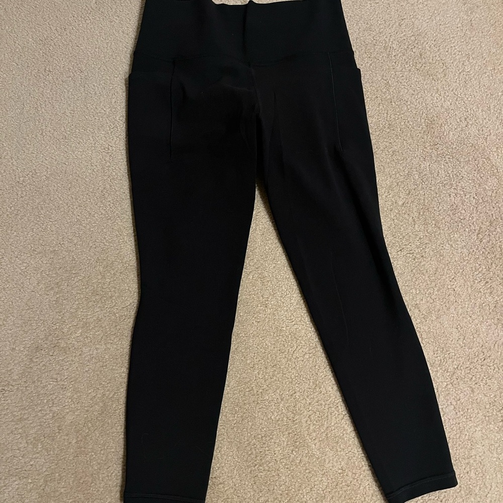 Athleta Black Salutation Stash Pocket II Leggings 7/8 with pockets. Never worn.
